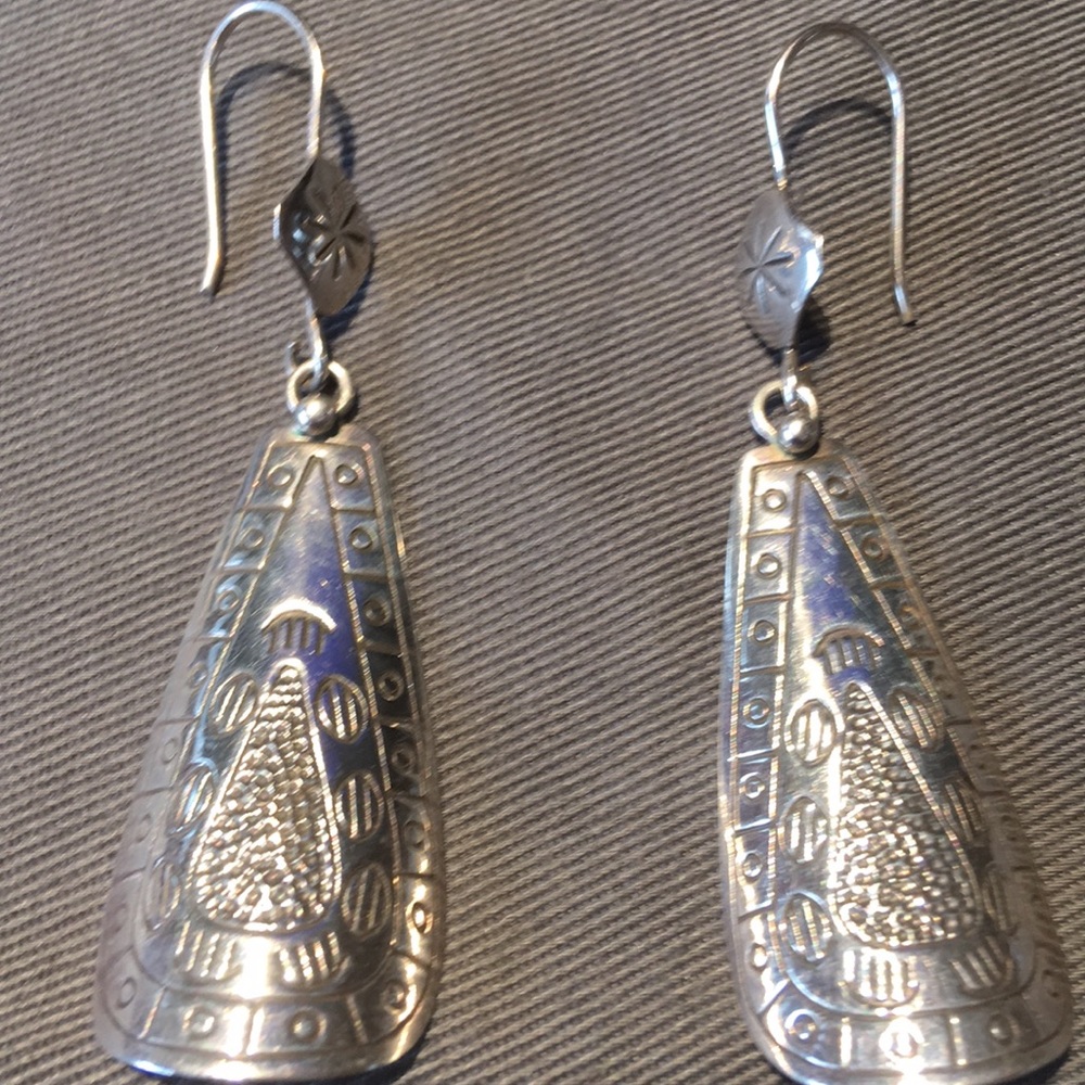 Rare Silpada long curved etched symbols earrings.